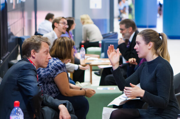 Civil servants in discussion at a conference