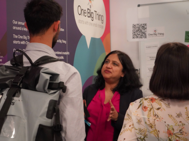 Civil servants discussing under a One Big Thing poster at Civil Service Live 2024.