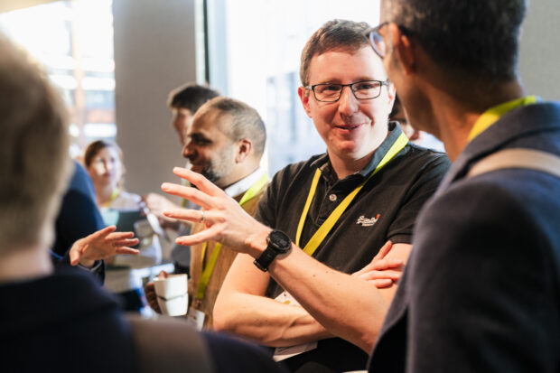 Ed McCutcheon at an event chatting to colleagues